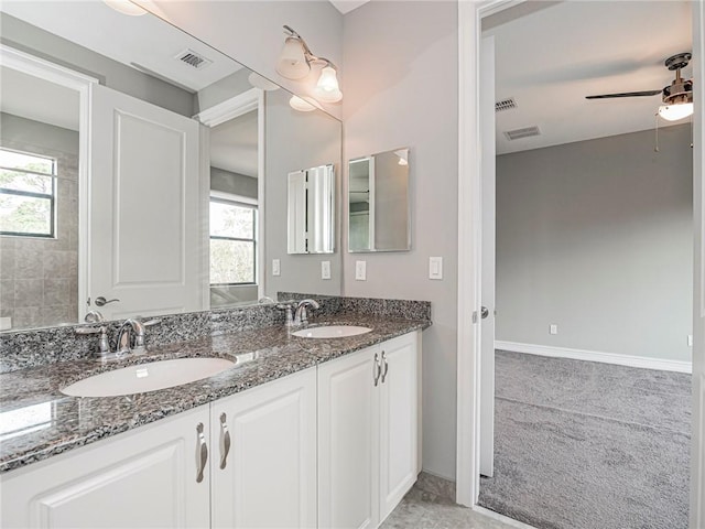 bathroom with ceiling fan, plenty of natural light, and vanity