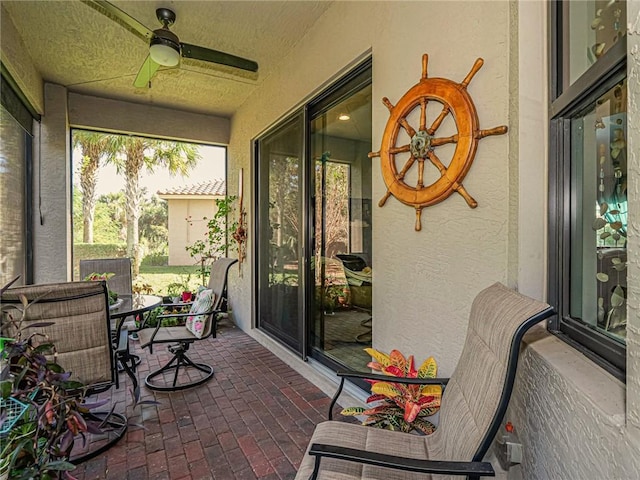 sunroom featuring ceiling fan