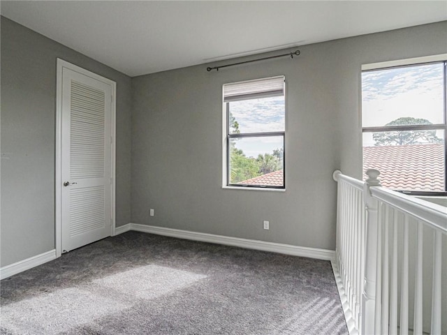 unfurnished bedroom featuring carpet and multiple windows