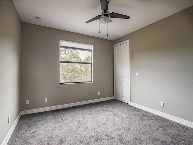 empty room with carpet floors and ceiling fan