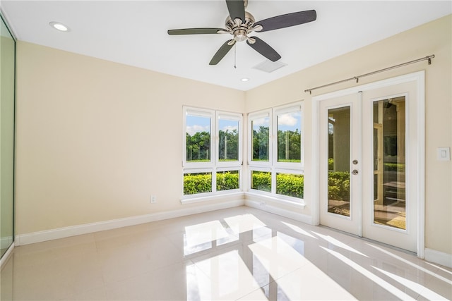 unfurnished sunroom featuring french doors and ceiling fan