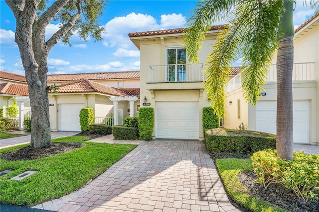 mediterranean / spanish-style home with a garage