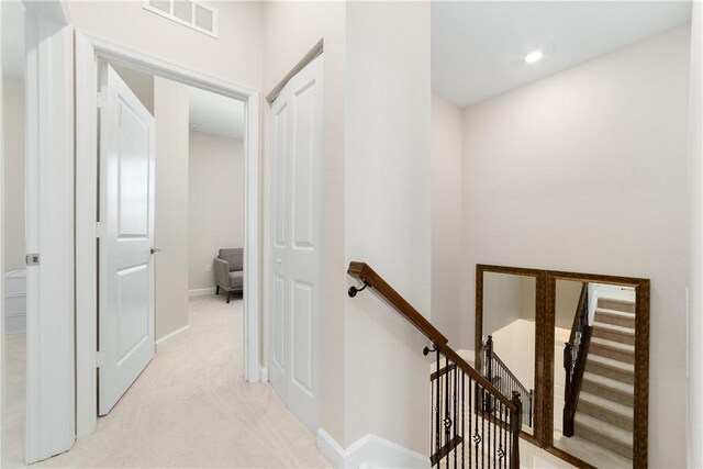 10134 W Villa Cir, Vero Beach, FL 32966 - corridor with an upstairs landing, light colored carpet, and baseboards