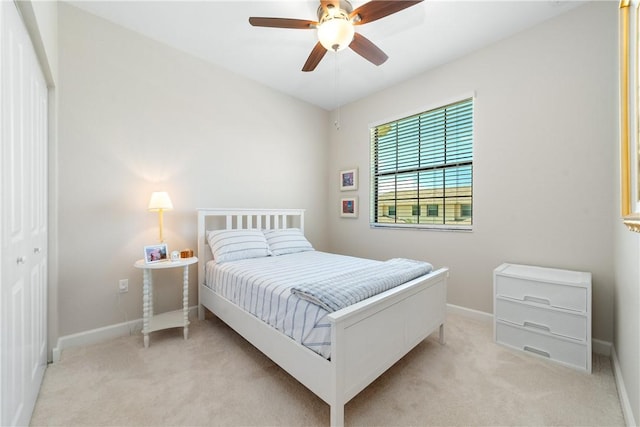 10134 W Villa Cir, Vero Beach, FL 32966 - bedroom with light carpet, baseboards, and ceiling fan