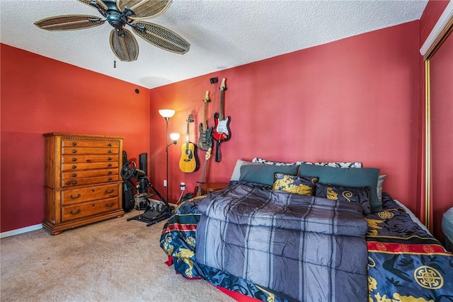 bedroom featuring a textured ceiling, carpet flooring, and a ceiling fan