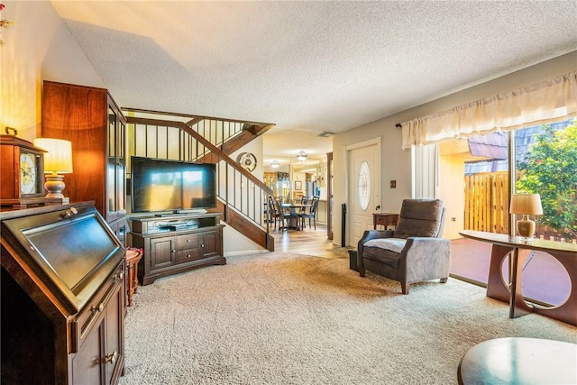 1170 6th Ave Unit 10A, Vero Beach, FL 32960 - living area with stairs, carpet floors, and a textured ceiling