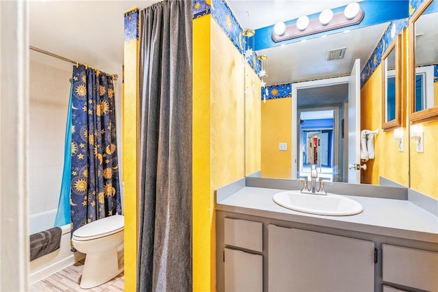 full bath featuring shower / bath combo, visible vents, toilet, wood finished floors, and vanity