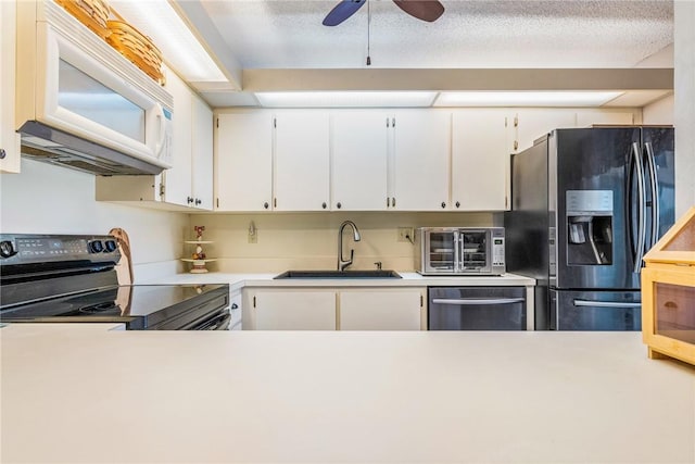 kitchen with white cabinets, stainless steel appliances, a sink, and light countertops