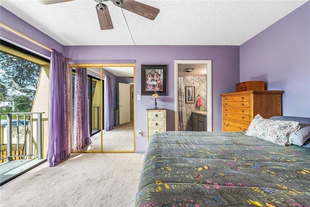 bedroom featuring a closet, light colored carpet, connected bathroom, ceiling fan, and a textured ceiling