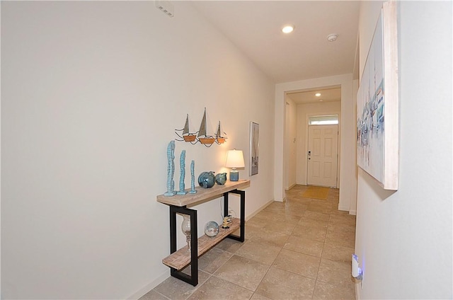 hall with light tile patterned flooring