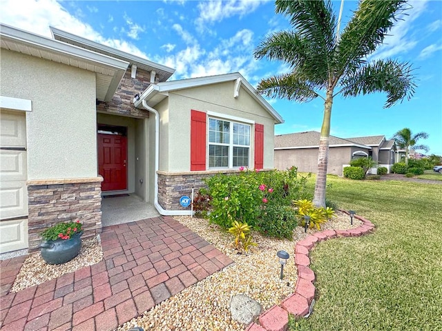 doorway to property featuring a lawn