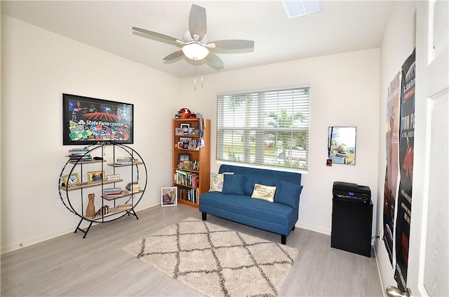 living area with ceiling fan and light wood-type flooring