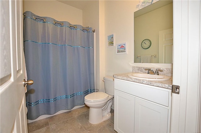 bathroom featuring vanity, a shower with shower curtain, and toilet