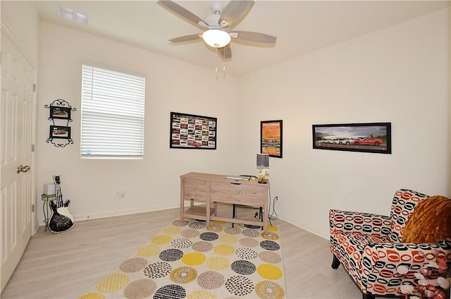 office with ceiling fan and light wood-type flooring