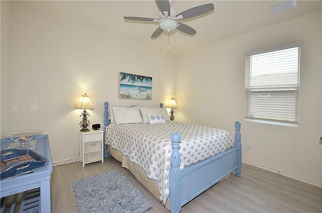 bedroom with hardwood / wood-style flooring and ceiling fan