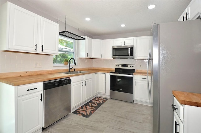 726 41st Ave, Vero Beach, FL 32968 - kitchen with appliances with stainless steel finishes, a sink, wooden counters, backsplash, and recessed lighting