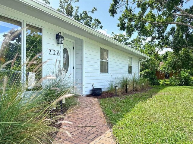 726 41st Ave, Vero Beach, FL 32968 - property entrance featuring a yard