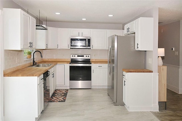 726 41st Ave, Vero Beach, FL 32968 - kitchen featuring appliances with stainless steel finishes, a sink, white cabinets, tasteful backsplash, and recessed lighting