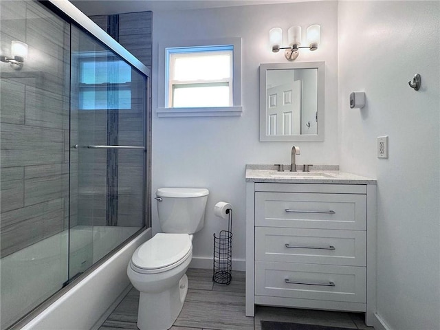 726 41st Ave, Vero Beach, FL 32968 - full bathroom featuring toilet, baseboards, vanity, and combined bath / shower with glass door