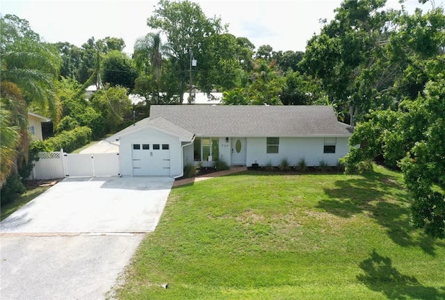 726 41st Ave, Vero Beach, FL 32968 - ranch-style home with driveway, an attached garage, and a gate