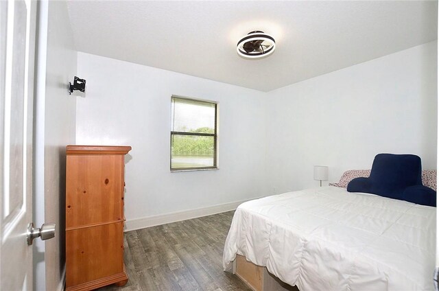 726 41st Ave, Vero Beach, FL 32968 - bedroom with dark wood-style flooring and baseboards
