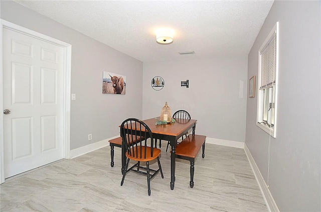 726 41st Ave, Vero Beach, FL 32968 - dining area with a textured ceiling and baseboards