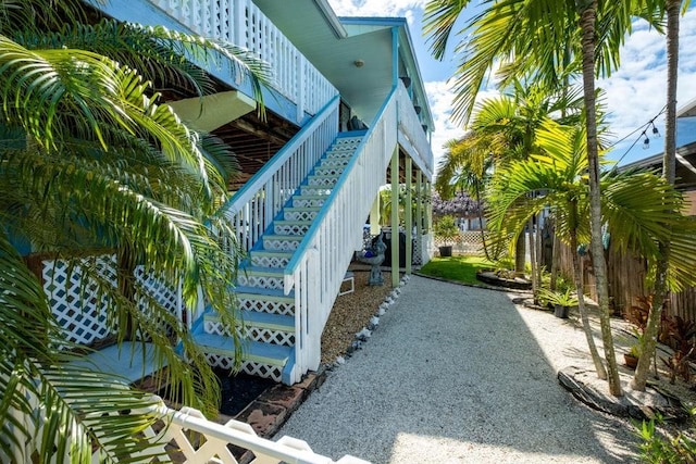 view of home's community with stairway and fence