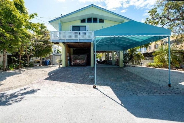 view of car parking with decorative driveway and a carport