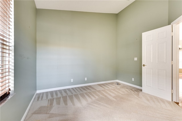 unfurnished room featuring plenty of natural light and light colored carpet