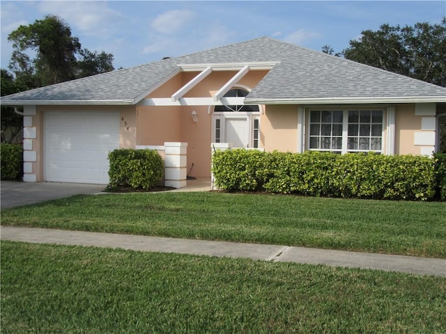 ranch-style home featuring a garage and a front lawn