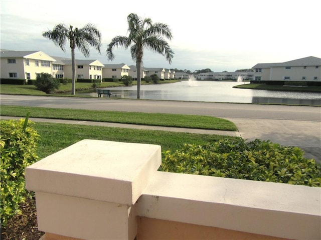 exterior space with a water view and a yard