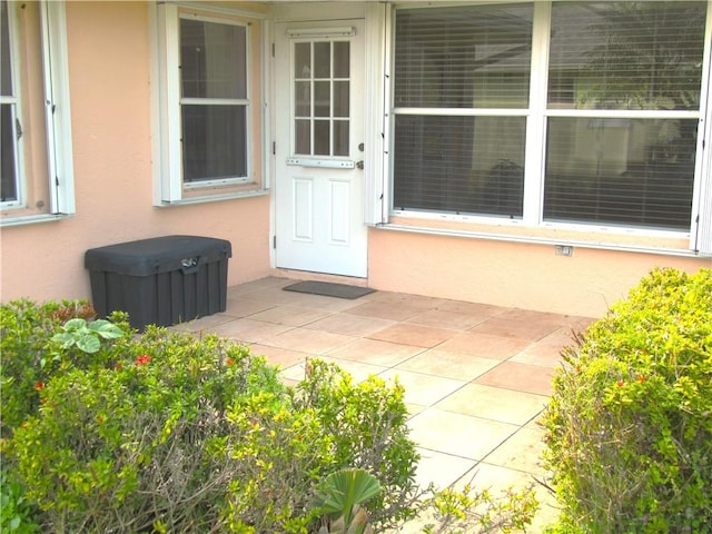 property entrance featuring a patio area