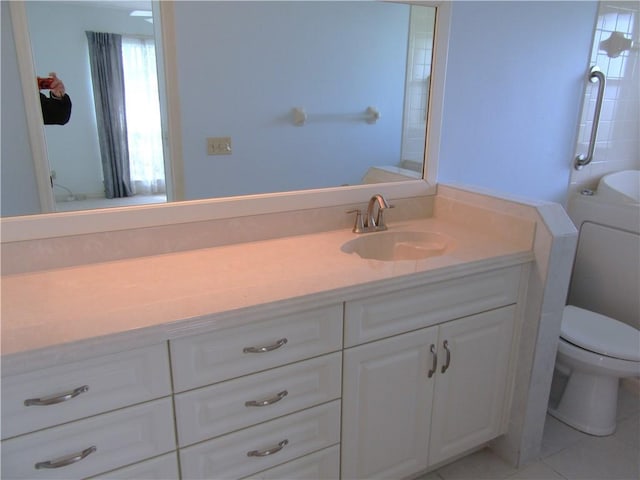 bathroom featuring toilet, tile patterned floors, and vanity