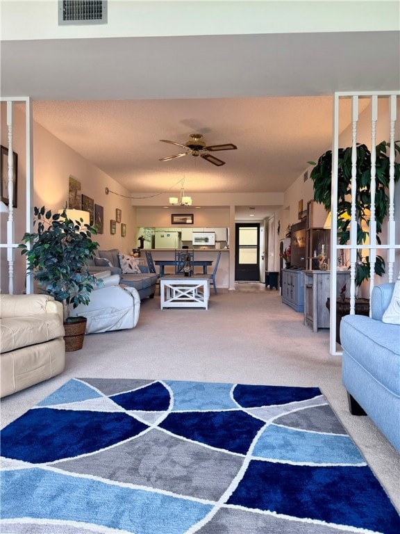 living room featuring ceiling fan and carpet floors