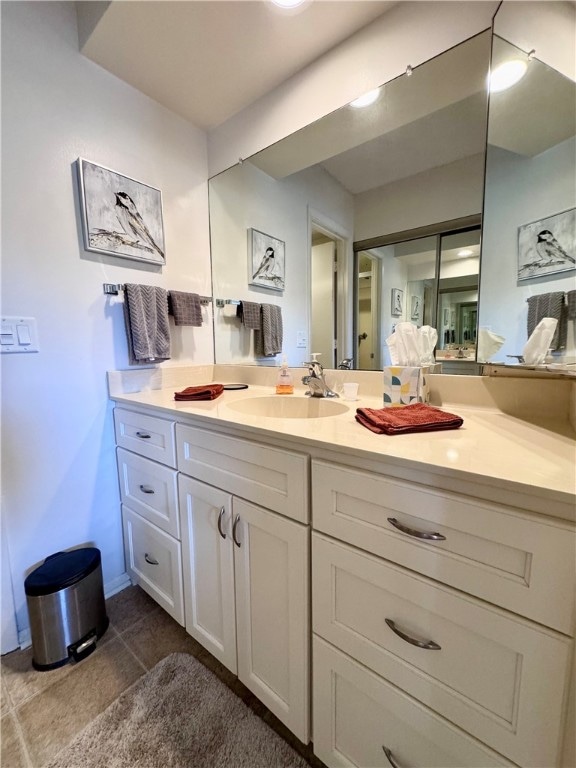 bathroom featuring tile patterned flooring and vanity