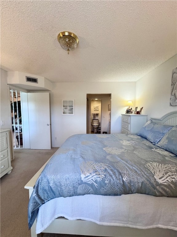 carpeted bedroom with a textured ceiling