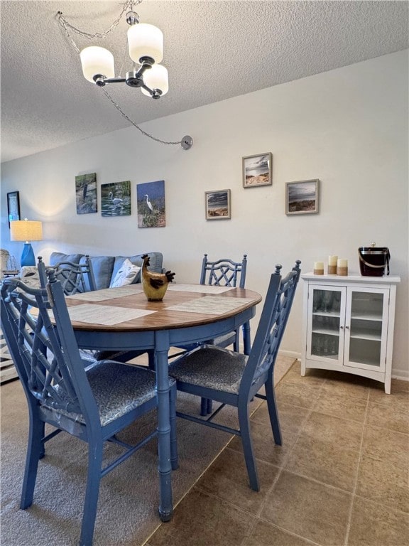 dining area featuring a textured ceiling and a notable chandelier