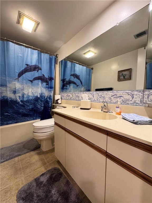 full bathroom featuring tile patterned flooring, vanity, shower / bath combo with shower curtain, and toilet