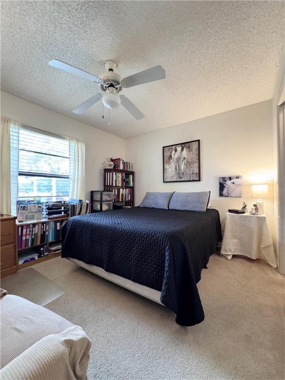 carpeted bedroom featuring a textured ceiling and ceiling fan