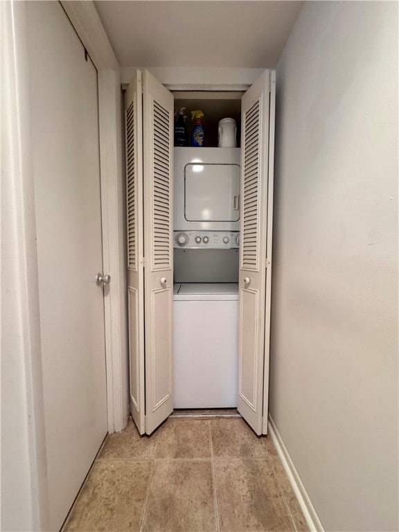 washroom featuring stacked washer and clothes dryer