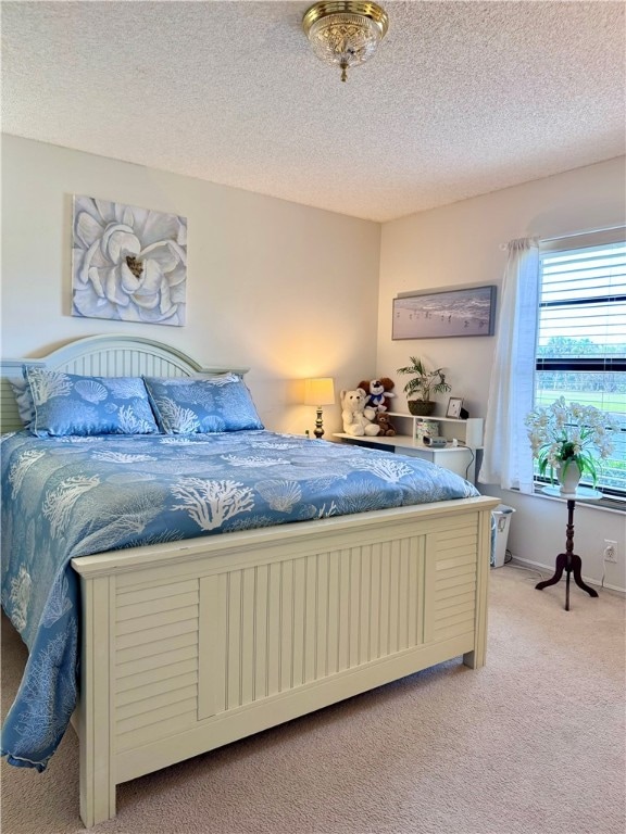 carpeted bedroom featuring a textured ceiling