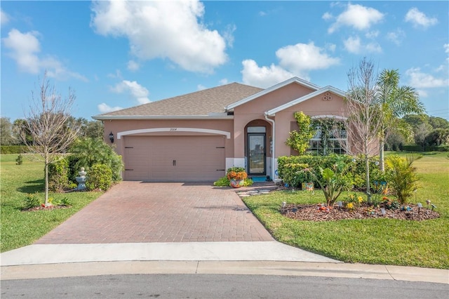 single story home with a garage and a front yard