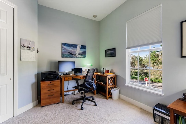 office with carpet flooring, a high ceiling, and baseboards