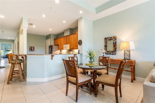 dining space with recessed lighting, visible vents, baseboards, and light tile patterned floors