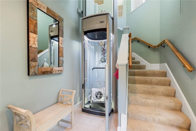 staircase featuring tile patterned flooring