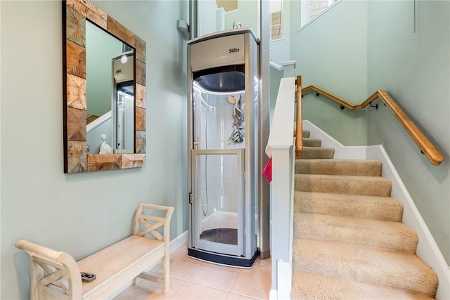 stairway with tile patterned floors