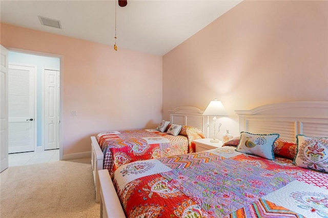 carpeted bedroom featuring visible vents and baseboards