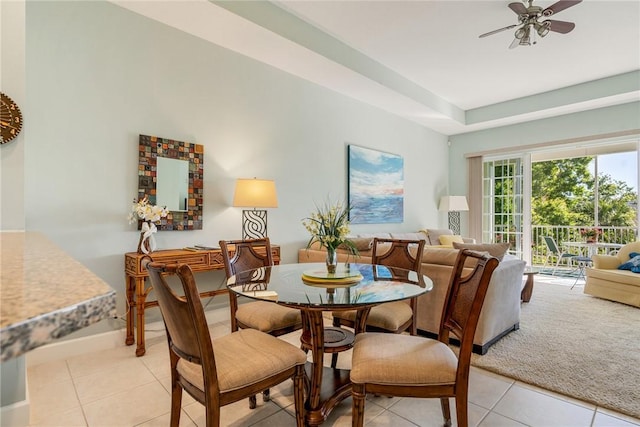 dining area featuring light tile patterned floors, light carpet, and ceiling fan