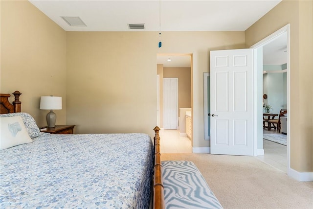 carpeted bedroom with visible vents and baseboards