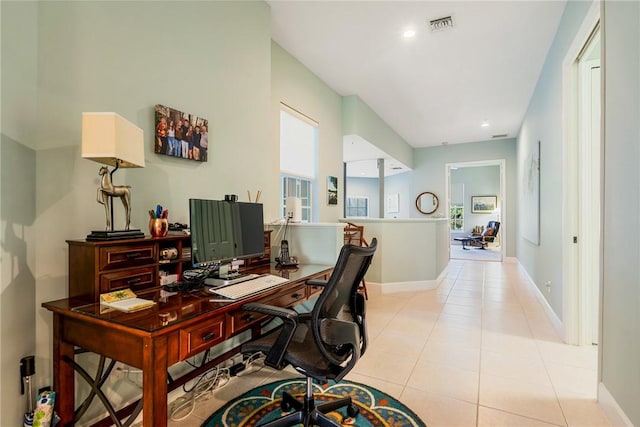 home office featuring light tile patterned flooring, baseboards, and visible vents